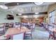 Bright dining area in a community clubhouse, featuring multiple tables and chairs at 14390 E Marina Dr # 601, Aurora, CO 80014