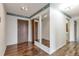 Hallway with wood floors, dark wood doors and mirrored closet at 14390 E Marina Dr # 601, Aurora, CO 80014