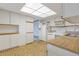 Bright kitchen with white appliances, cabinetry, and a tile floor at 14390 E Marina Dr # 601, Aurora, CO 80014