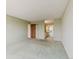 Spacious living room featuring carpet floors, and a doorway leading to the kitchen and other rooms at 14390 E Marina Dr # 601, Aurora, CO 80014