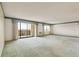 Spacious living room with large windows and a sliding door leading to a balcony at 14390 E Marina Dr # 601, Aurora, CO 80014