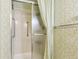 Bathroom features shower with curtain and tile walls, with grab bar at 14390 E Marina Dr # 601, Aurora, CO 80014