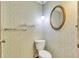 Toilet area features floral wallpaper, oval mirror, and decorative light fixture at 14390 E Marina Dr # 601, Aurora, CO 80014