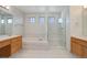Bright bathroom with a soaking tub, separate glass enclosed shower and double sink vanity at 2608 S Troy Ct, Aurora, CO 80014