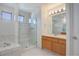 Bright bathroom featuring a glass enclosed shower, tiled walls, and a wood vanity at 2608 S Troy Ct, Aurora, CO 80014