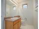 Bathroom featuring a wood vanity, large mirror, and tiled floors at 2608 S Troy Ct, Aurora, CO 80014