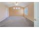 Spacious bedroom featuring vaulted ceilings, neutral walls, carpet floors, and ample natural light from multiple windows at 2608 S Troy Ct, Aurora, CO 80014