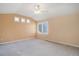 A bedroom with vaulted ceilings, neutral walls, carpet floors, and large window at 2608 S Troy Ct, Aurora, CO 80014