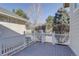 Back deck with white railing offers an outdoor seating area, perfect for entertaining or relaxing at 2608 S Troy Ct, Aurora, CO 80014