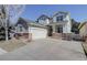 Two-story home featuring gray siding, a brick foundation, and a spacious driveway at 2608 S Troy Ct, Aurora, CO 80014