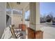 Cozy front porch featuring brick columns and comfortable seating area at 2608 S Troy Ct, Aurora, CO 80014