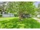 Well-maintained front yard with lush green grass and mature trees, creating a serene and inviting curb appeal at 2608 S Troy Ct, Aurora, CO 80014