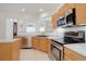 Well-lit kitchen with stainless steel appliances and ample counter space at 2608 S Troy Ct, Aurora, CO 80014