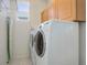 Functional laundry room with modern washer and dryer units, and storage cabinets at 2608 S Troy Ct, Aurora, CO 80014