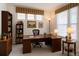 Bright office space with desk, bookshelves, and window at 2608 S Troy Ct, Aurora, CO 80014