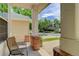 View from a cozy front porch showing brickwork detail and outdoor seating with view of a tree-lined street at 2608 S Troy Ct, Aurora, CO 80014