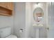 Powder room with pedestal sink and wood storage cabinet at 2608 S Troy Ct, Aurora, CO 80014