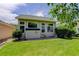 Bright sunroom featuring ample windows and a charming exterior, perfect for relaxing and enjoying the view at 2608 S Troy Ct, Aurora, CO 80014