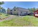 Image shows the backyard with grass, trees, a tool shed, and a view of the house at 1057 Reed Ranch Rd, Boulder, CO 80302