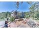 A scenic view from the backyard shows landscaping, trees and a fire pit area at 1057 Reed Ranch Rd, Boulder, CO 80302