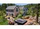 This spacious backyard features a hot tub and a fire pit perfect for gatherings, all set in a tranquil, natural setting at 1057 Reed Ranch Rd, Boulder, CO 80302