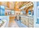 Bathroom featuring wood vaulted ceilings, double sinks, granite counters, and decorative light fixtures at 1057 Reed Ranch Rd, Boulder, CO 80302