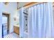 Bright bathroom with tiled floors, shower with white tile surround and adjacent vanity at 1057 Reed Ranch Rd, Boulder, CO 80302