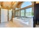 Bathroom featuring wood vaulted ceilings, soaking tub, and separate shower with large picture window at 1057 Reed Ranch Rd, Boulder, CO 80302