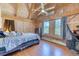 Bright bedroom features vaulted ceilings, wood paneled walls, and large windows showcasing the outdoor view at 1057 Reed Ranch Rd, Boulder, CO 80302