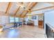 Upper bonus room featuring hardwood floors, vaulted ceilings, built-in shelves and a piano at 1057 Reed Ranch Rd, Boulder, CO 80302