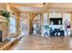 Open-concept living room with hardwood floors, stone fireplace, and access to other rooms at 1057 Reed Ranch Rd, Boulder, CO 80302