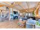 Open living room featuring wood beams, hardwood floors, and staircase access at 1057 Reed Ranch Rd, Boulder, CO 80302