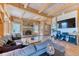 Inviting living room boasts a stone fireplace, wood beam details, and open floor plan at 1057 Reed Ranch Rd, Boulder, CO 80302