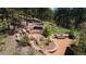 Inviting outdoor space features a hot tub, fire pit, and picnic table nestled amongst natural rock outcroppings and lush foliage at 1057 Reed Ranch Rd, Boulder, CO 80302