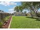 This lovely backyard features green grass, mature trees, and a well maintained wooden fence at 224 Agate Way, Broomfield, CO 80020