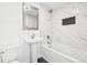 Modern bathroom features white marble tile, shower over tub, and a pedestal sink at 224 Agate Way, Broomfield, CO 80020