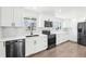 Modern kitchen features stainless steel appliances, white cabinets, and quartz countertops at 224 Agate Way, Broomfield, CO 80020