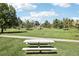 A scenic park view with a picnic table, walking path, and open grassy area at 224 Agate Way, Broomfield, CO 80020