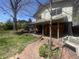Lovely backyard with a brick patio, mature trees, seating, and a charming garden at 12682 W Louisiana Ave, Lakewood, CO 80228