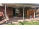 Covered backyard patio featuring brick flooring, seating, and access to the home at 12682 W Louisiana Ave, Lakewood, CO 80228