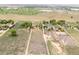 Expansive aerial view of a large property featuring open fields, scattered trees, and residential structures at 6363 County Road 20, Longmont, CO 80504