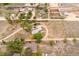 Scenic aerial view of a rural property with scattered homes, outbuildings, mature trees, and expansive land at 6363 County Road 20, Longmont, CO 80504