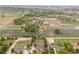 Aerial view of a spacious property showcasing lush greenery, scattered homes, and well-maintained landscapes at 6363 County Road 20, Longmont, CO 80504