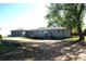 Ranch home with attached two-car garage, large yard, and mature trees, offering comfortable suburban living at 6363 County Road 20, Longmont, CO 80504