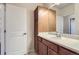 Bathroom with a vanity, mirror, and a door to another room at 199 Quebec St # M, Denver, CO 80220