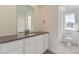 Bright bathroom featuring a white vanity with a dark countertop and modern fixtures at 39896 Floyd St, Elizabeth, CO 80107