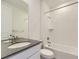 Bathroom featuring modern vanity with gray countertop, tile flooring, and shower/tub combination at 39896 Floyd St, Elizabeth, CO 80107