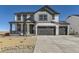 Charming two-story home with gray trim, multi-car garage and a welcoming covered front porch at 39896 Floyd St, Elizabeth, CO 80107