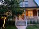 Brick home with a welcoming front porch and landscaping at 3409-3415 W Moncrieff Pl, Denver, CO 80211