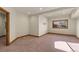 Finished basement bedroom with carpet and large window at 10385 Grande Vista Ct, Lone Tree, CO 80124
